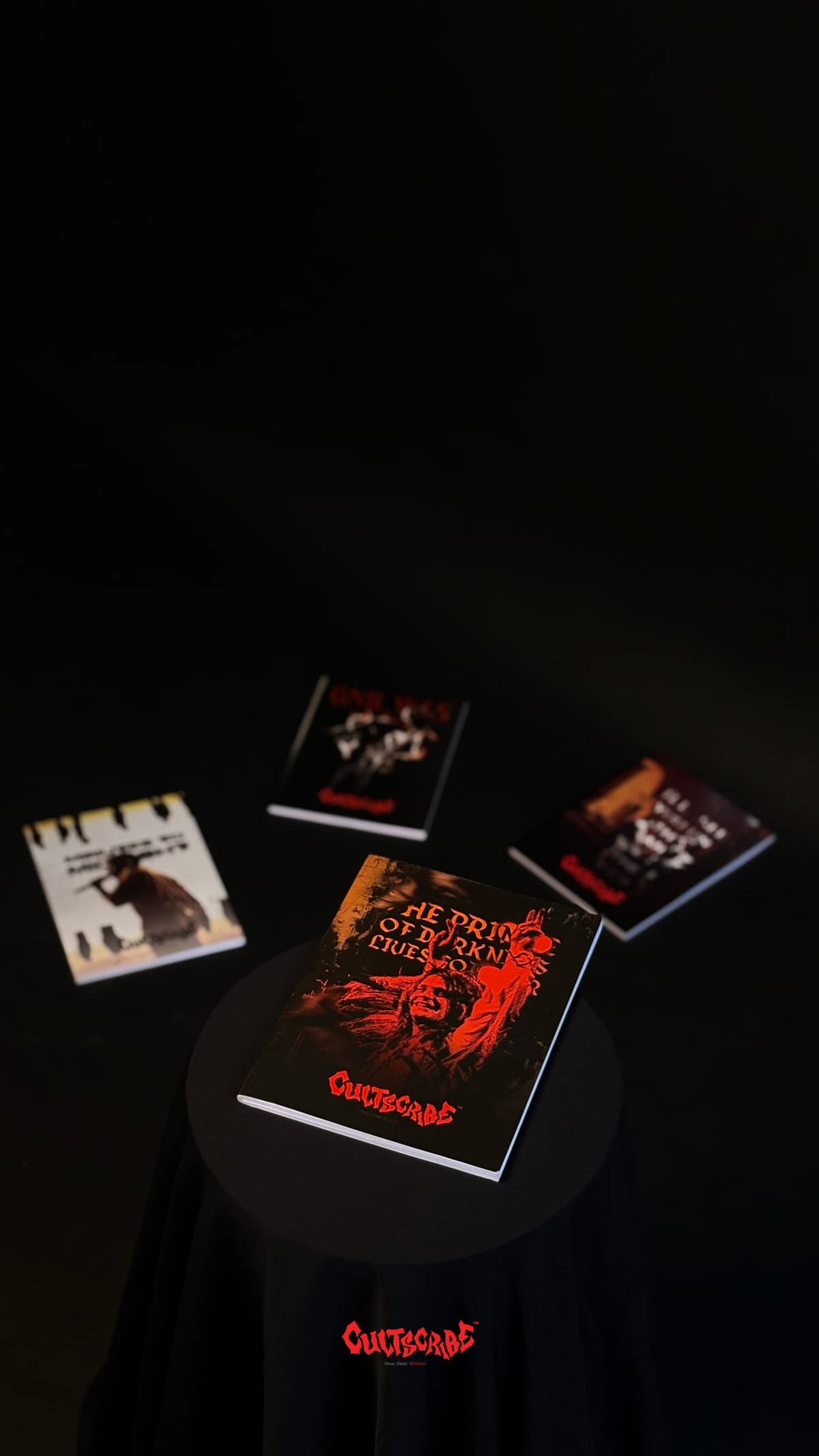 CultScribe product showcase — Prince of Darkness cover art on a pedestal with additional notebooks behind.