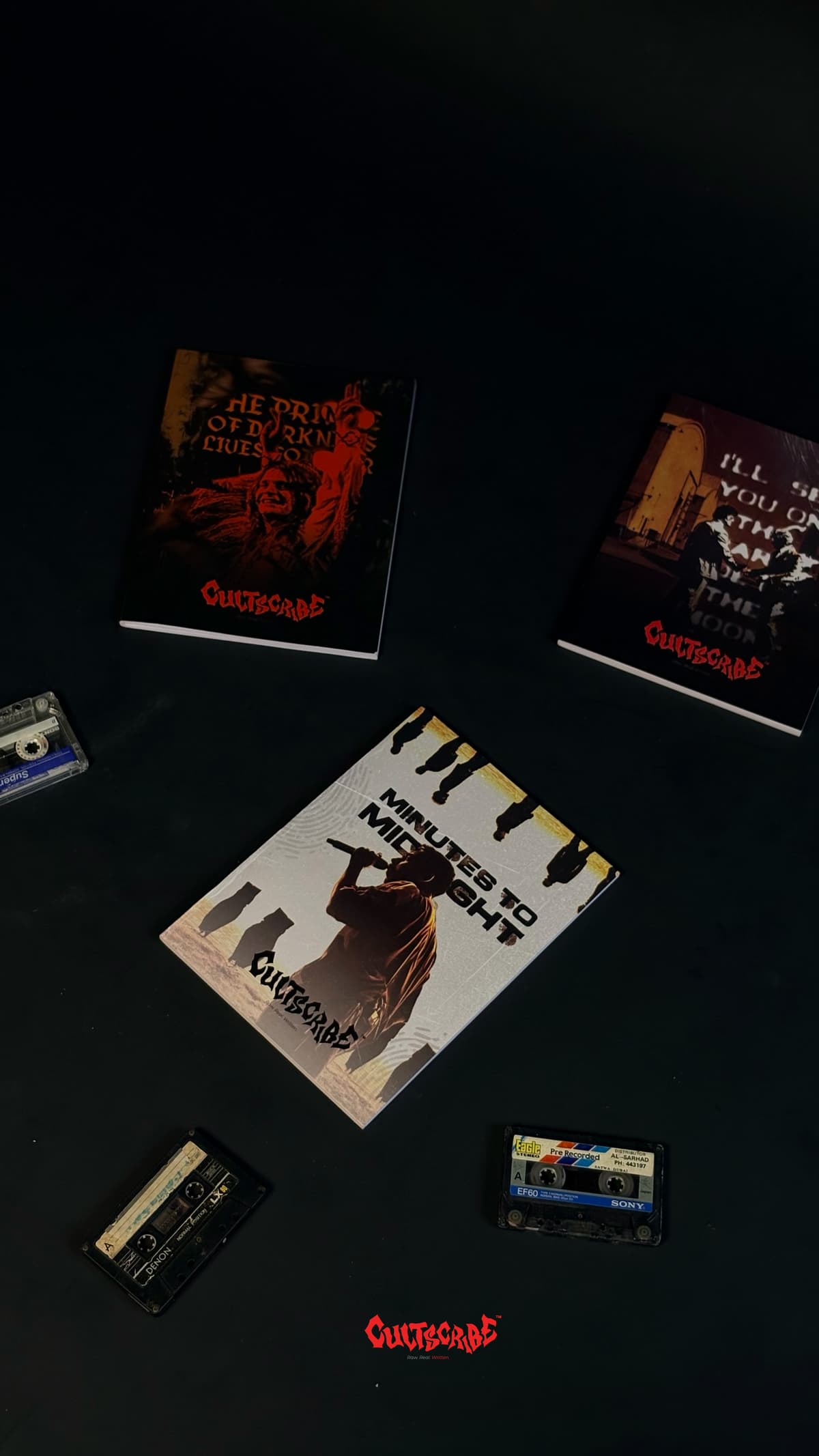 CultScribe flat lay — Minutes to Midnight, Prince of Darkness, and Dark Side notebooks with vintage cassettes.
